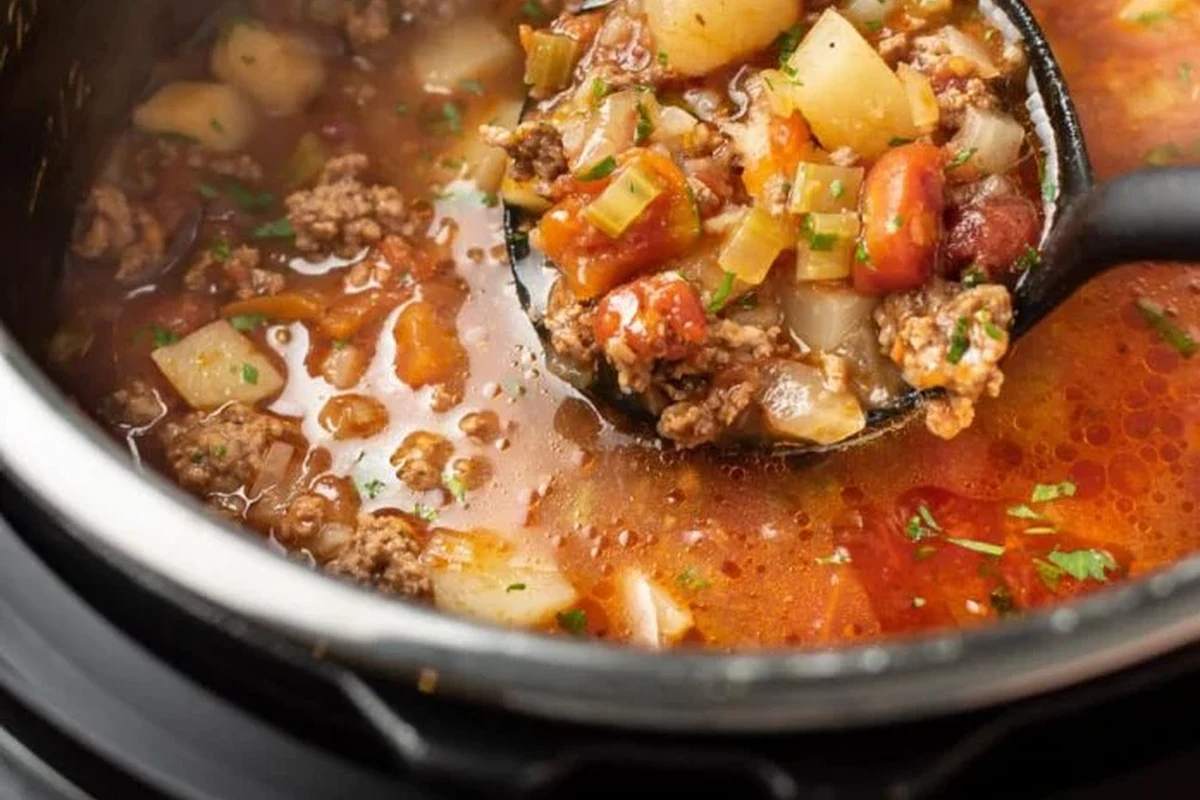 Easy Instant Pot Soup Recipe | Quick, Healthy & Flavorful One-Pot Meals 2 A steaming bowl of hearty vegetable and chicken soup prepared in an Instant Pot, featuring fresh herbs and root vegetables.