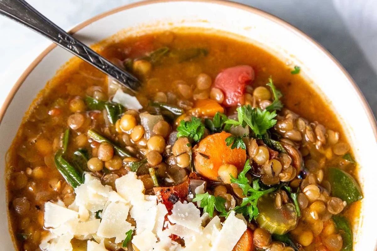 Easy Instant Pot Soup Recipe | Quick, Healthy & Flavorful One-Pot Meals 3 A steaming bowl of hearty vegetable and chicken soup prepared in an Instant Pot, featuring fresh herbs and root vegetables.
