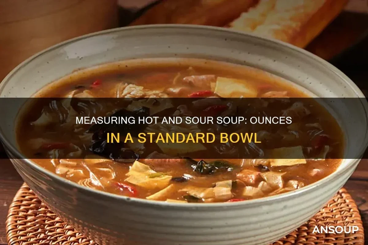 A steaming bowl of hearty vegetable soup on a wooden table, showcasing a standard 12-ounce serving size.
