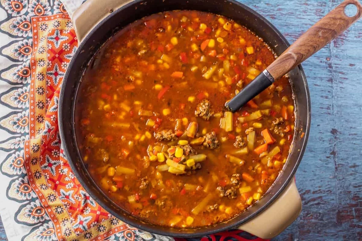Picadillo Soup Recipe: A Hearty Belizean Comfort Food Guide 3 A steaming bowl of Belizean picadillo soup with ground meat, diced carrots, potatoes, and fresh cilantro.