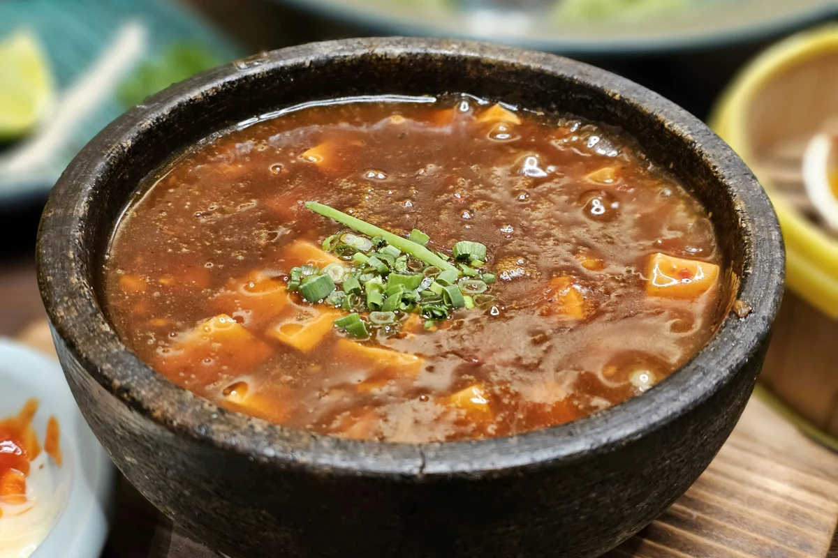 A steaming bowl of traditional Belizean soup served in a small, perfect portion.