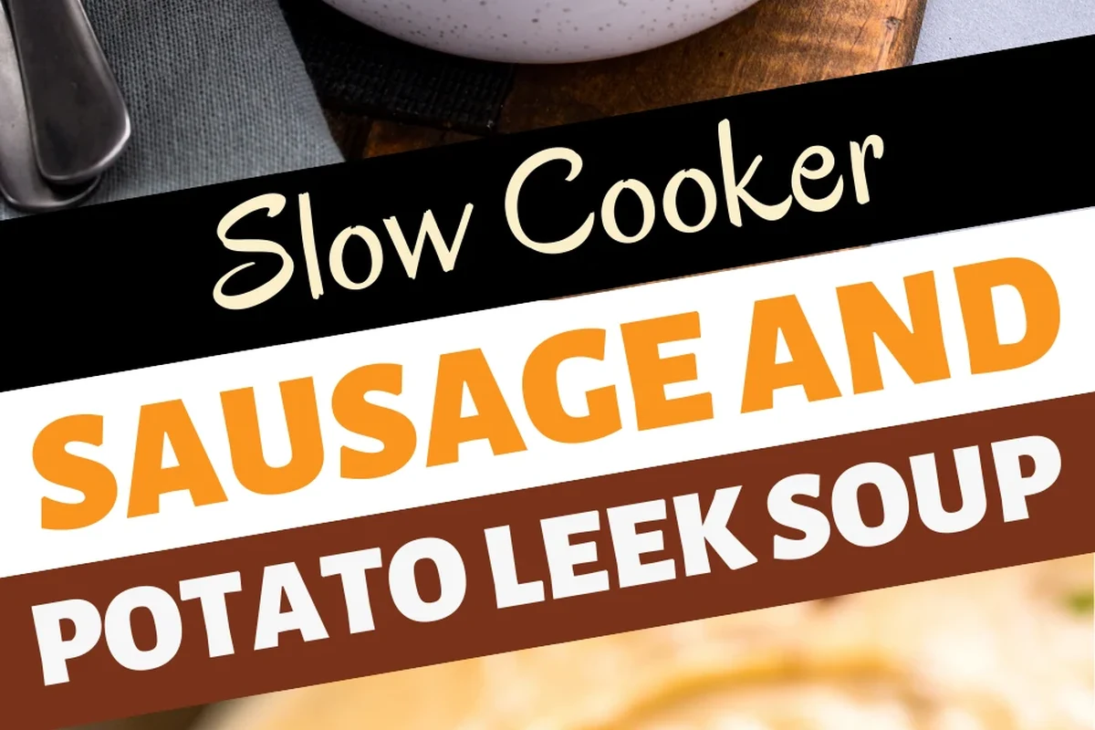 A steaming bowl of creamy potato leek soup with sliced browned sausage and fresh herbs on a rustic table.