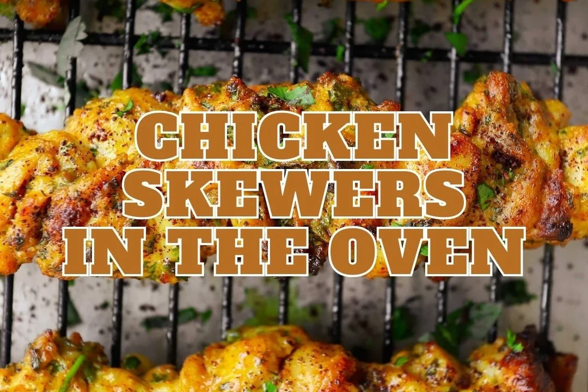 Juicy, perfectly charred chicken skewers on a baking sheet with colorful vegetables, ready to serve.
