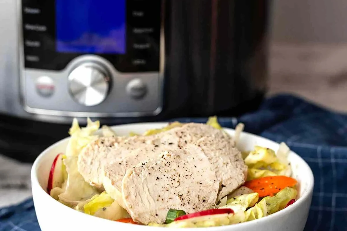 A freshly shredded chicken dish prepared in an Instant Pot with aromatic spices and lime.