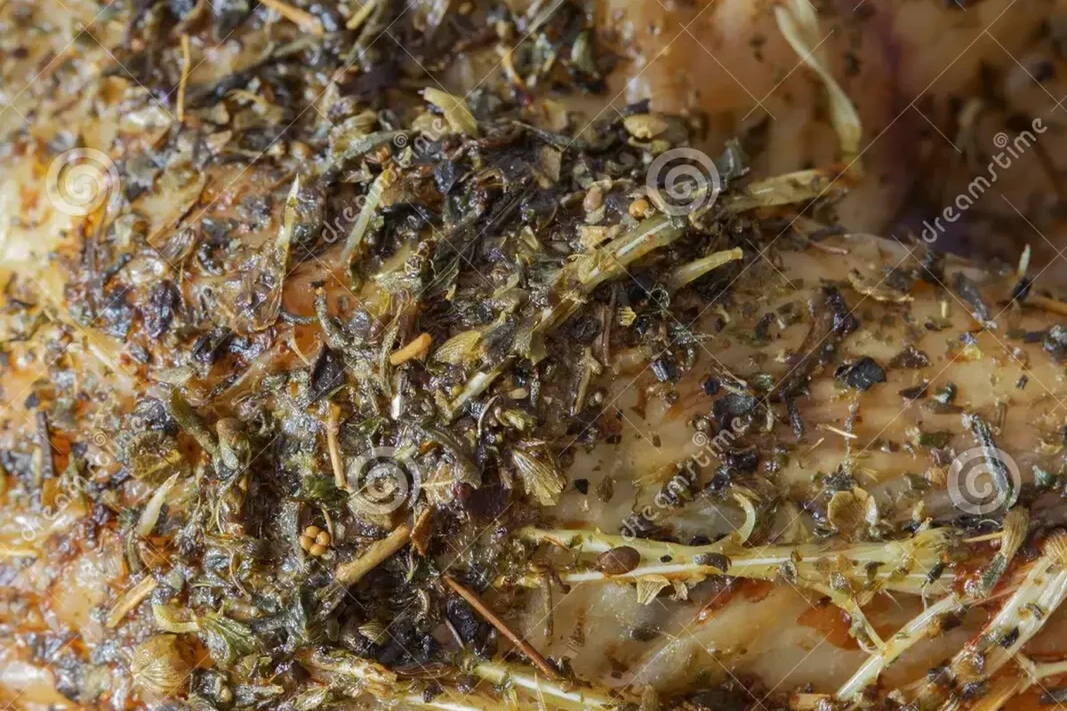 A golden roasted whole chicken seasoned with herbs and spices on a rustic platter.