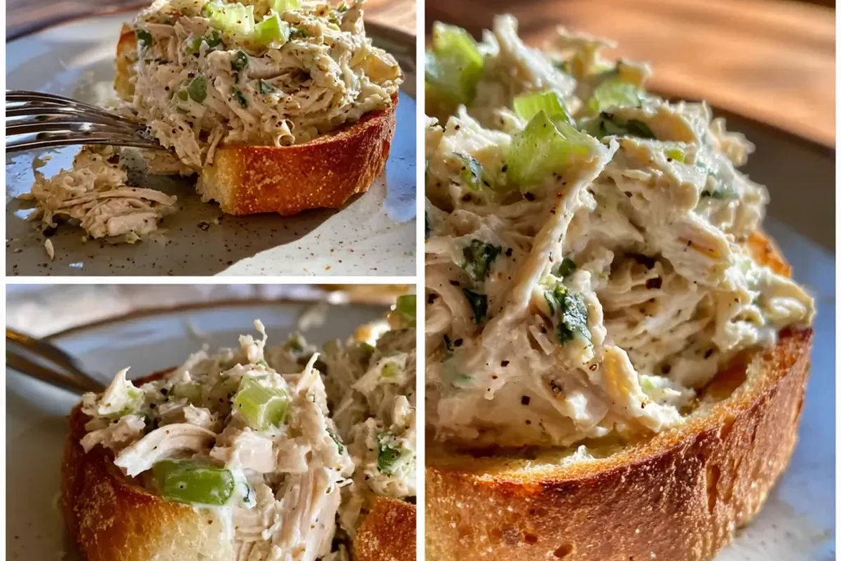 A bowl of shredded chicken salad with celery and herbs, presented on a rustic wooden table.