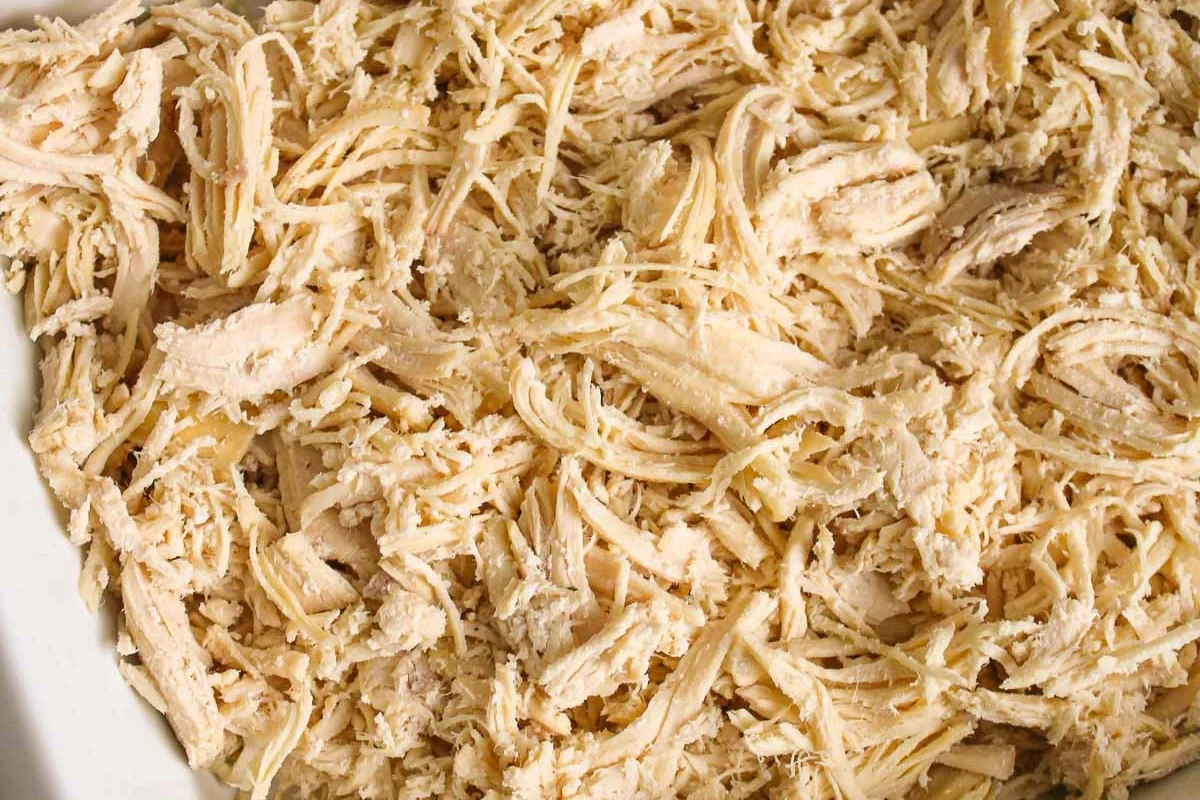 A tray of perfectly roasted, golden-brown shredded chicken ready for meal prep.