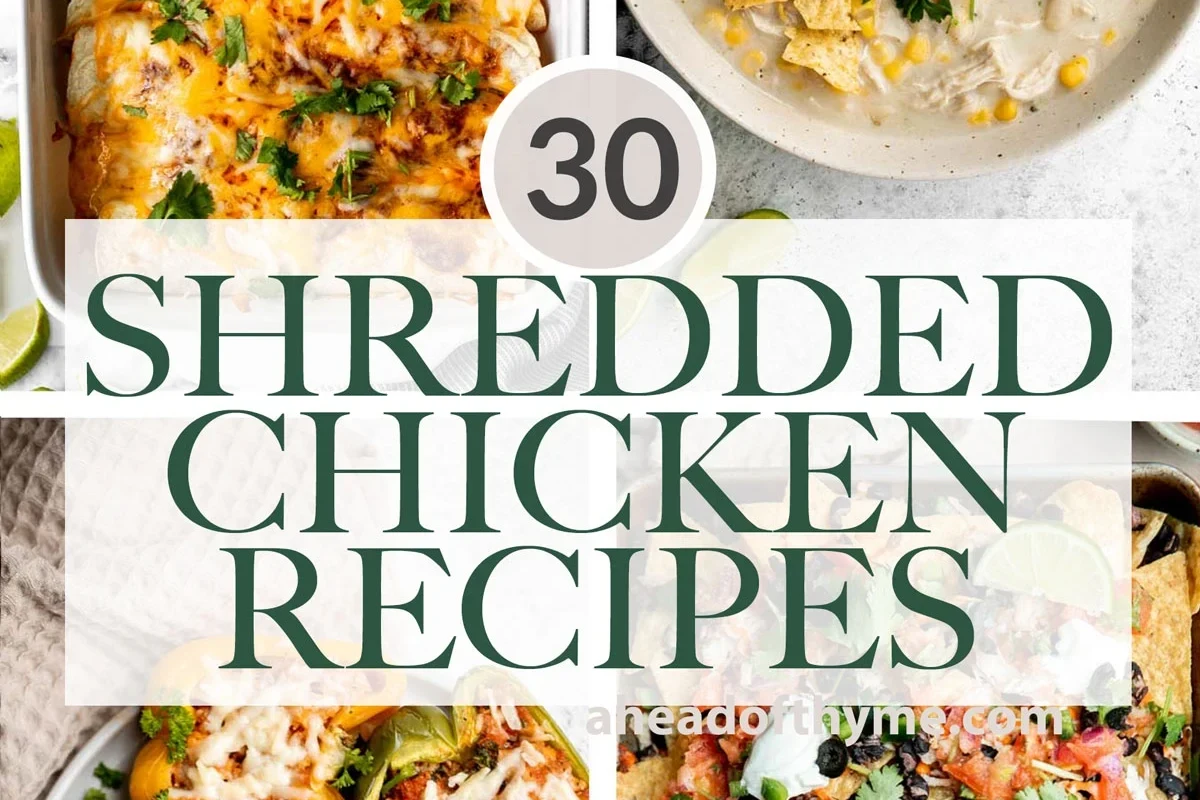 A bowl of freshly shredded, juicy cooked chicken with fresh herbs on a wooden kitchen surface.