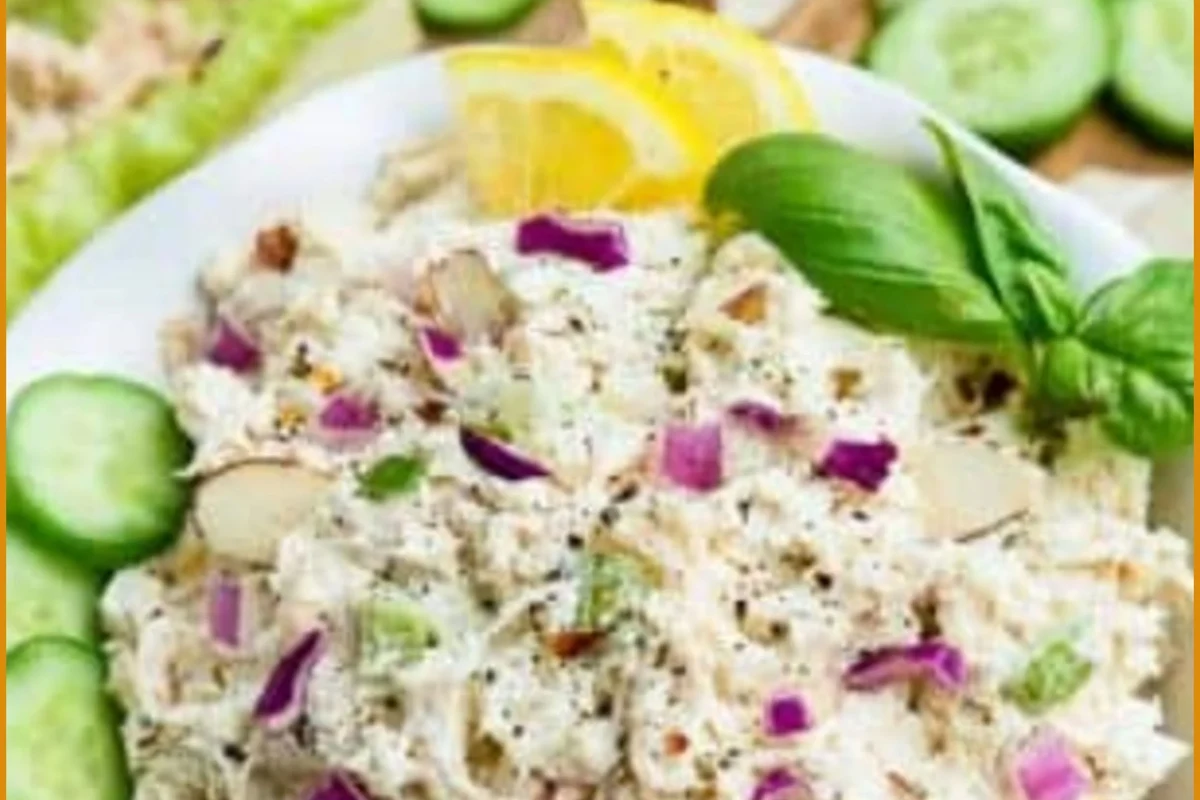 A bowl of perfectly shredded, tender chicken with fresh herbs and lime wedges, representing versatile meal prep.