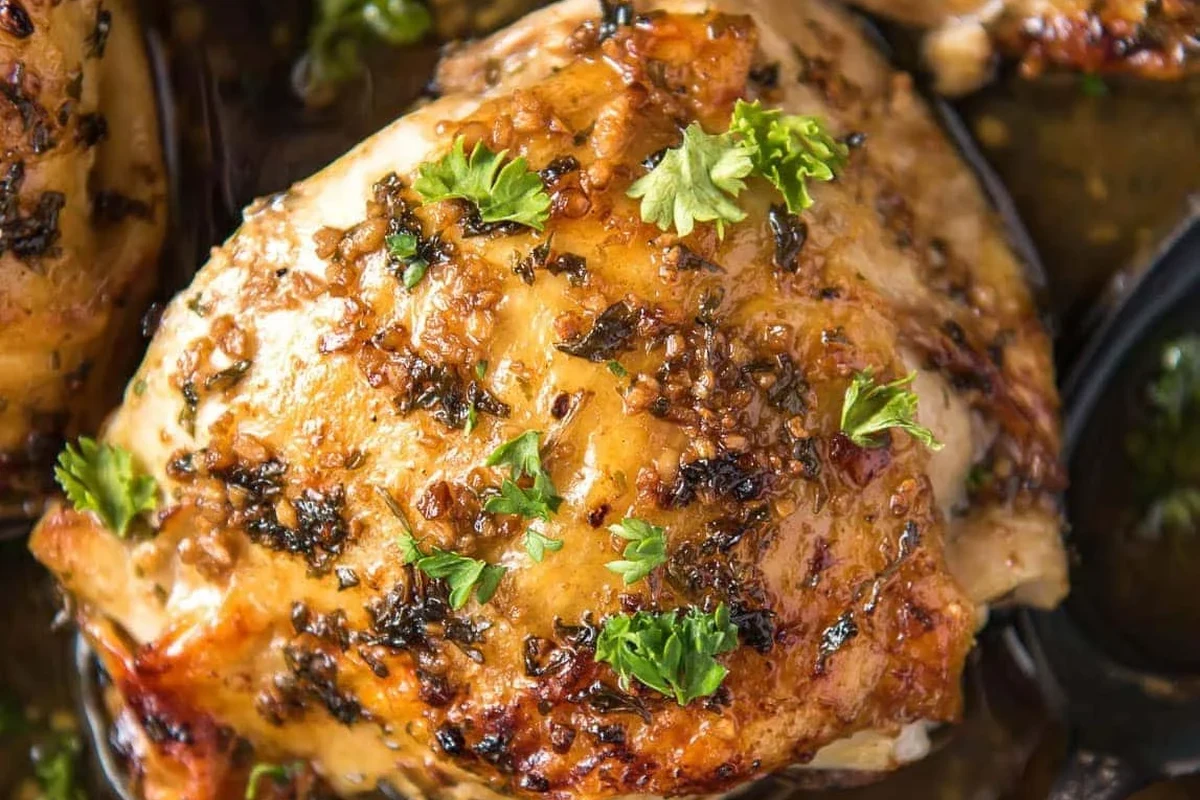 Golden-brown broiled chicken pieces on a metal rack with a savory herb rub.